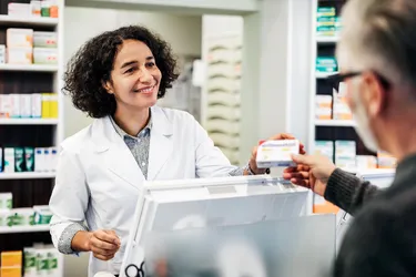A pharmacy technician may be the first person a customer sees when filling a prescription at a store pharmacy. (Photo credits: DigitalVision/Getty Images) 