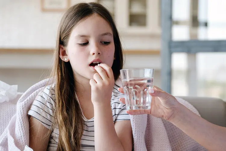 photo of child taking medication