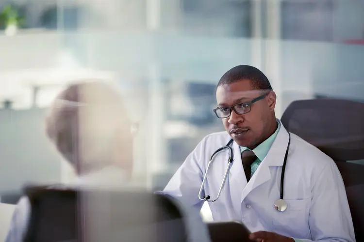 photo of doctor talking with senior male patient