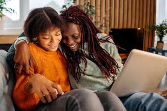 photo of mother and daughter on couch