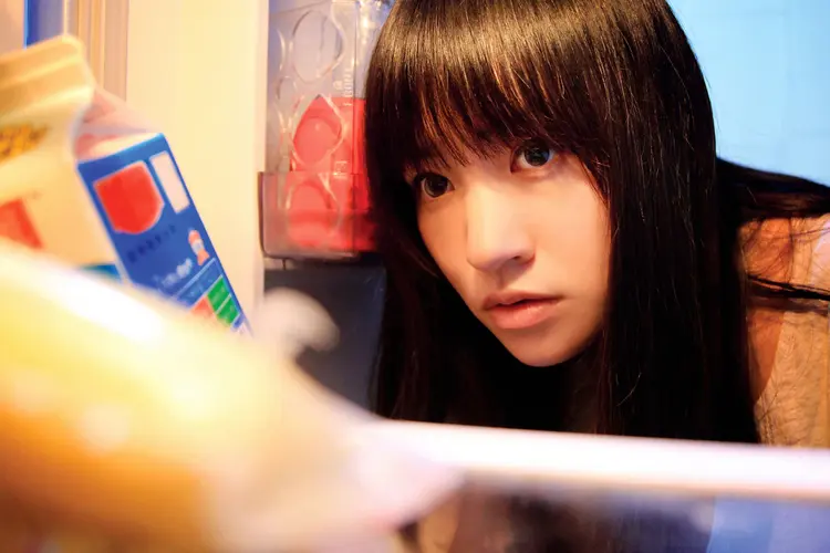photo of young woman looking in refrigerator