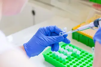 photo of lab researcher using pipette