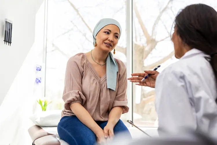 photo of doctor talking with female cancer patient