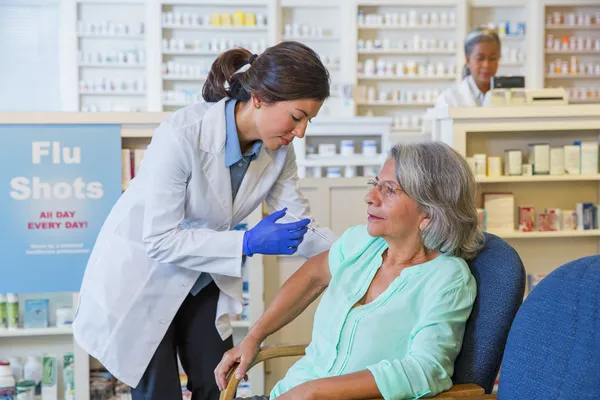 photo of pharmacist administering flu shot