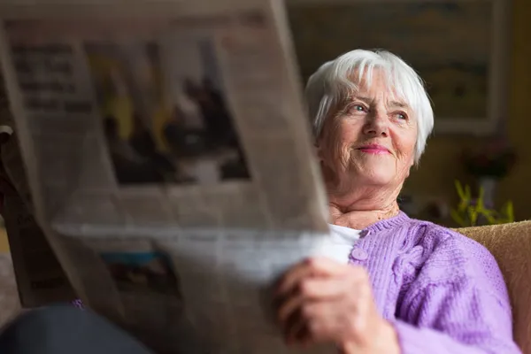 photo of person reading newspaper