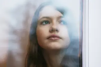 photo of girl looking out window