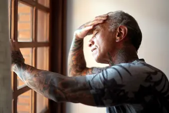 photo of tired man rubbing his forehead