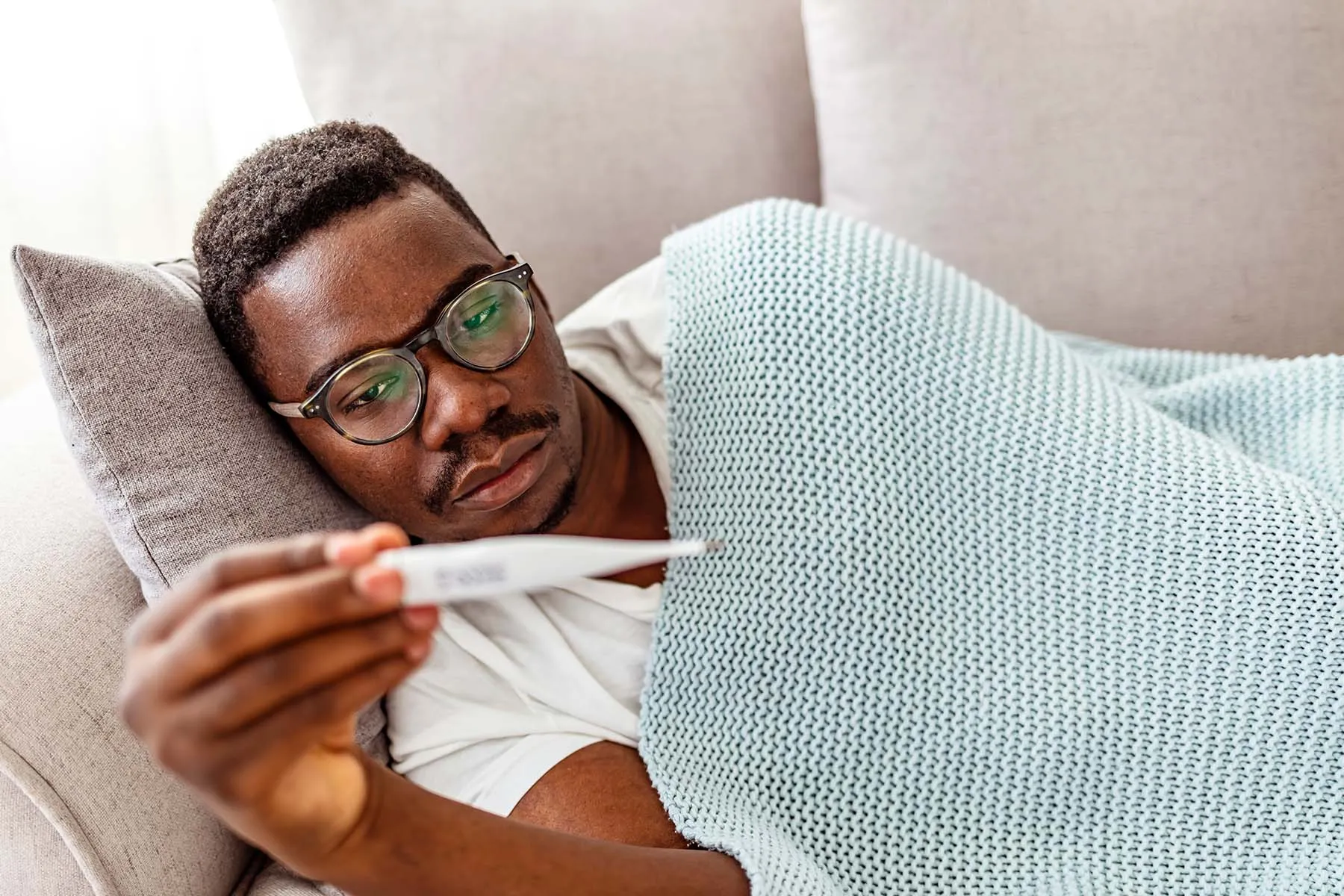 photo of man taking temperature