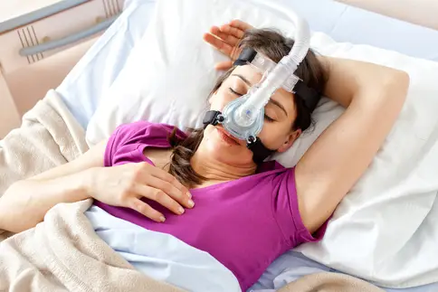 photo of woman sleeping with cpap machine