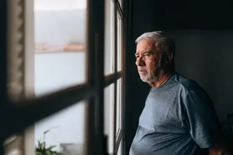 photo of man looking out window