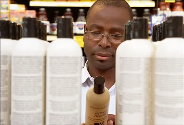 man browsing shampoos