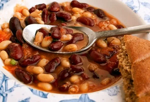 Two bean soup with spoon and bread