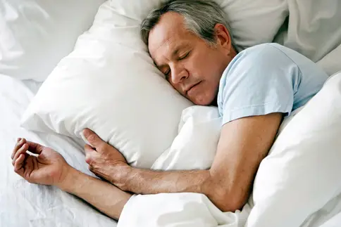 photo of senior man sleeping soundly in bed