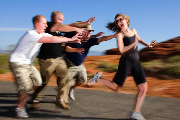 photo of woman running from people on jog