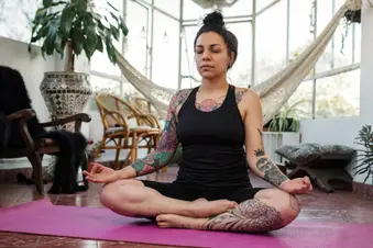 photo of woman holding yoga pose at home