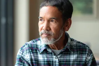 photo of mature man looking out window