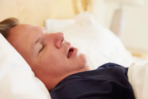 photo of man snoring in bed