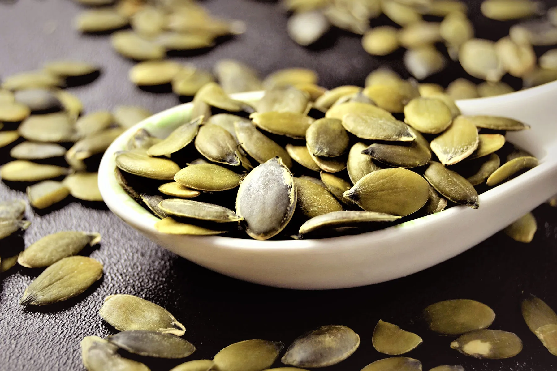 photo of spoonful of pumpkin seeds