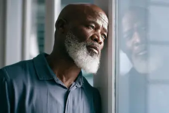 photo of man looking out window