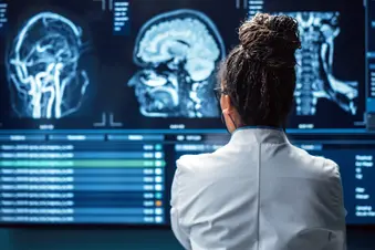 photo of neurosurgeon reviewing MRI scans of brain