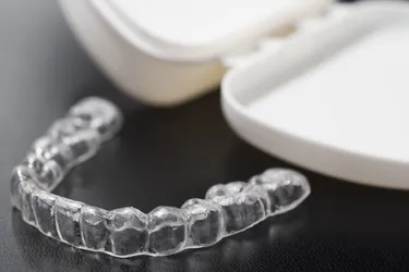 A mouth guard, also called a night guard, can help protect your teeth from the effects of grinding them at night. Another name for these devices is occlusal splints. (Photo Credit: iStock/Getty Images)