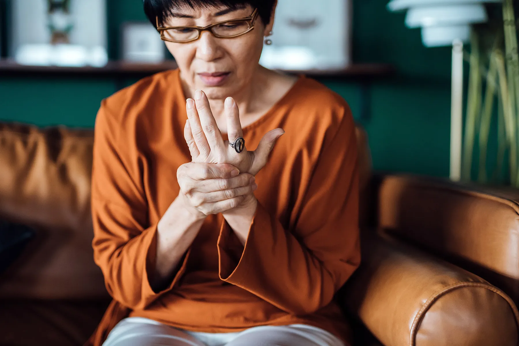 photo of senior woman rubbing sore hands