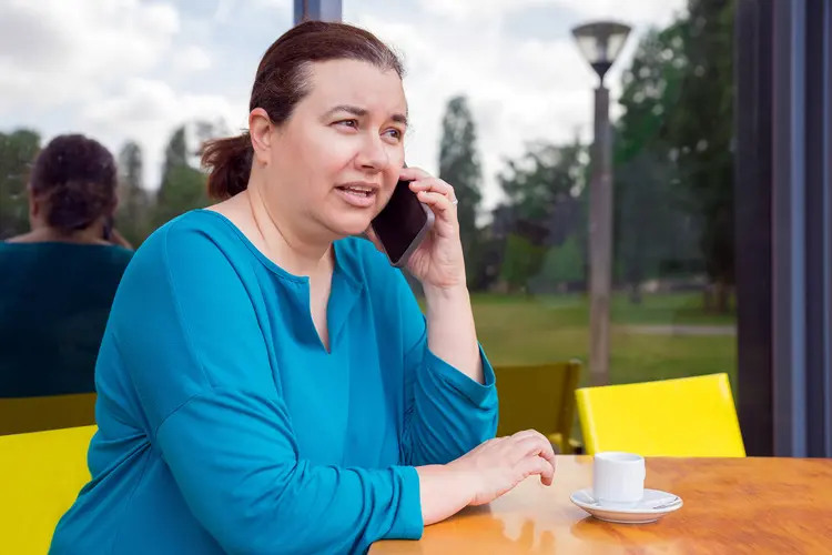 photo of mature woman talking on smartphone