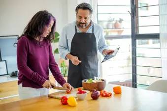 photo of mature couple preparing healthy salad