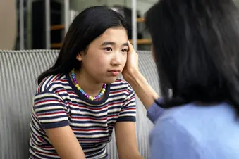 photo of mother comforting unhappy daughter