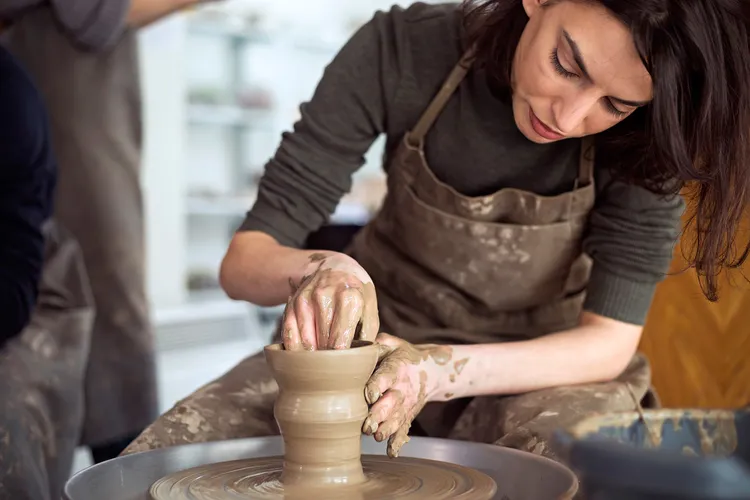 photo of woman making pottery