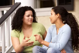 photo of friends talking on front steps of home