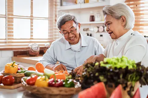 photo of senior couple preparing healthy meal