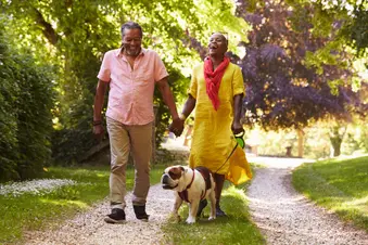 photo of couple walking dog