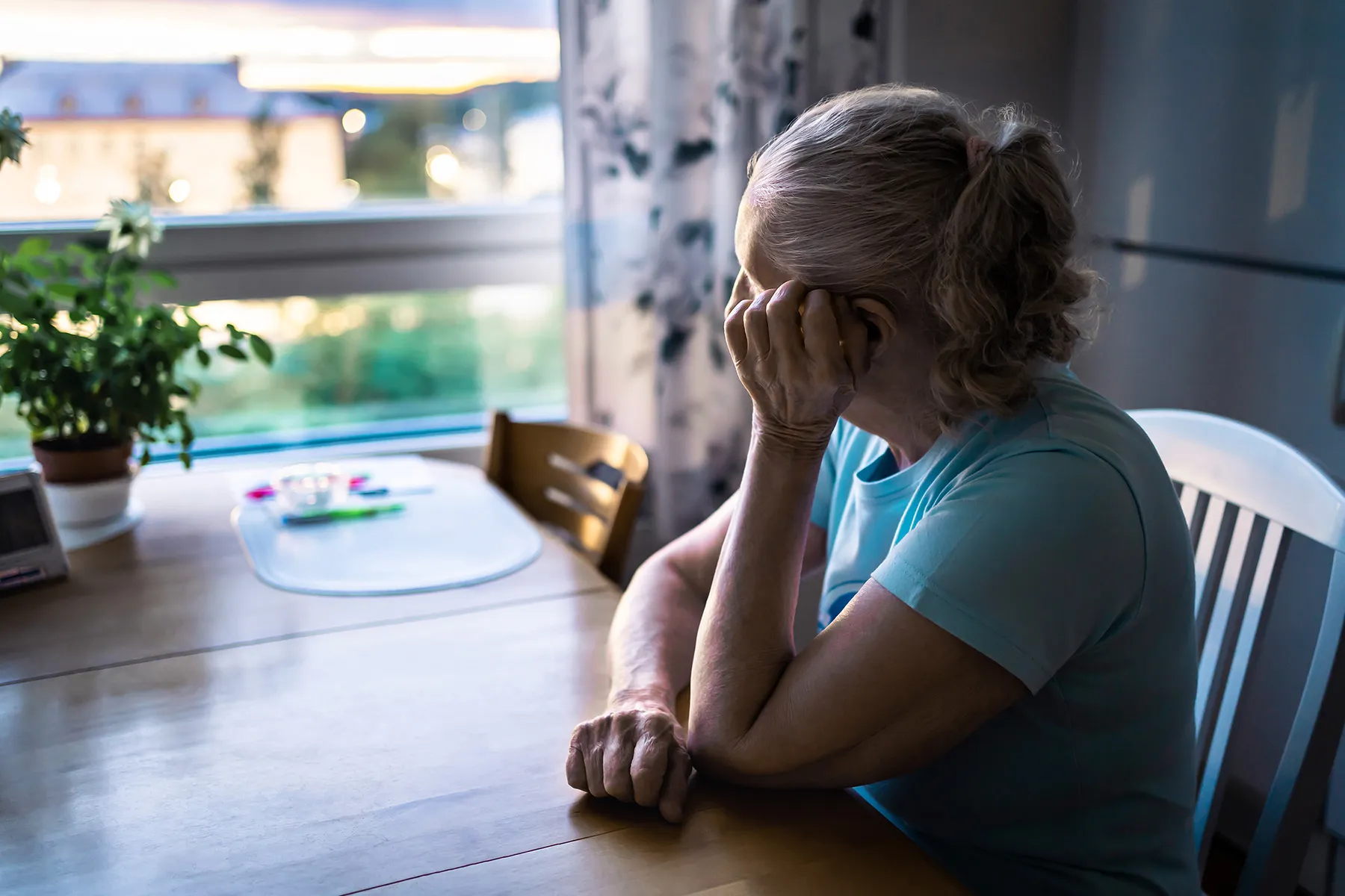 photo of woman looking out window