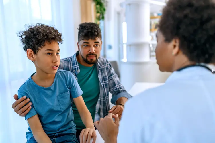 photo of parent and child listening to doctor