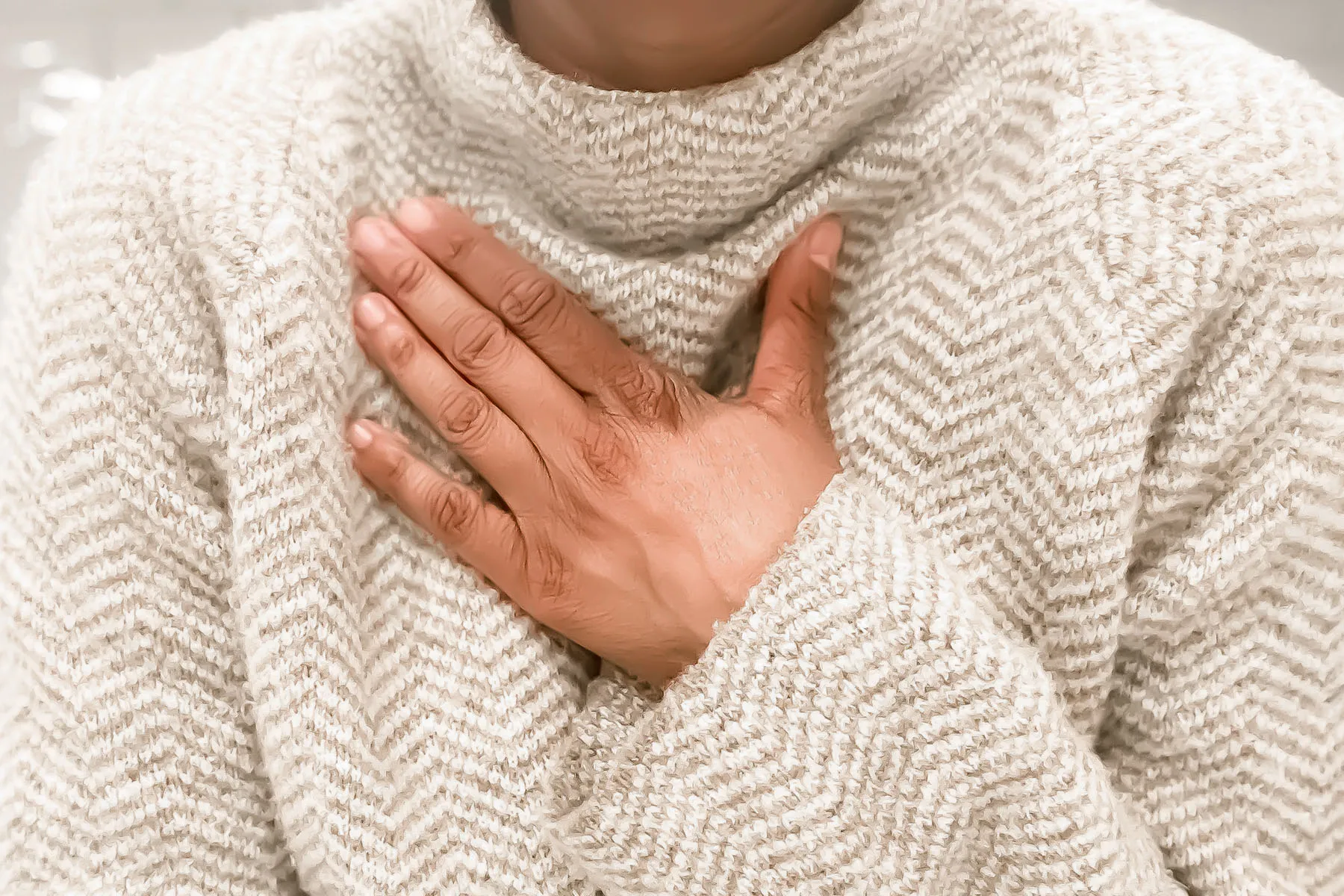 photo of woman holding chest