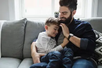 photo of father and son hugging