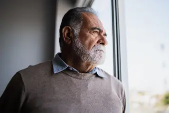 photo of hispanic man looking out window
