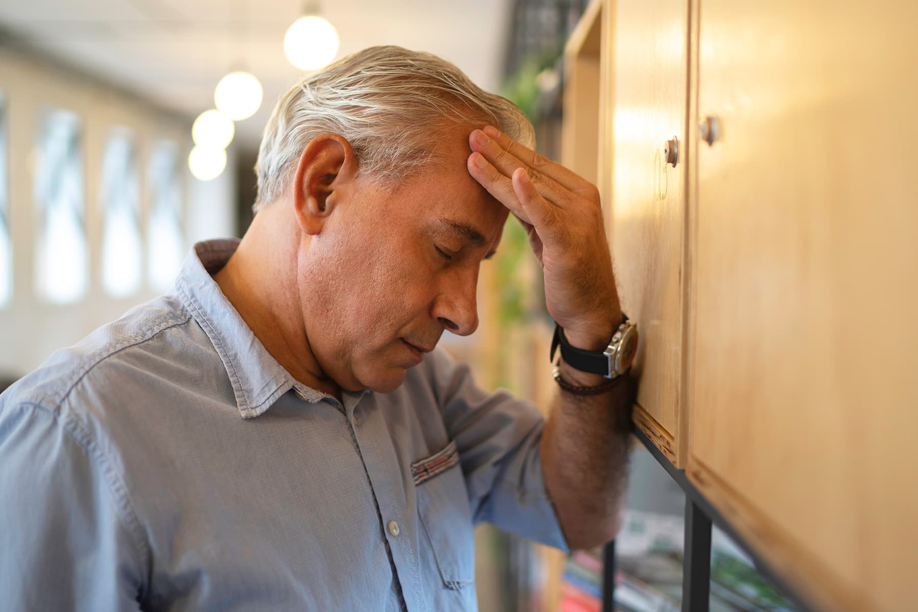 photo of senior man with headache