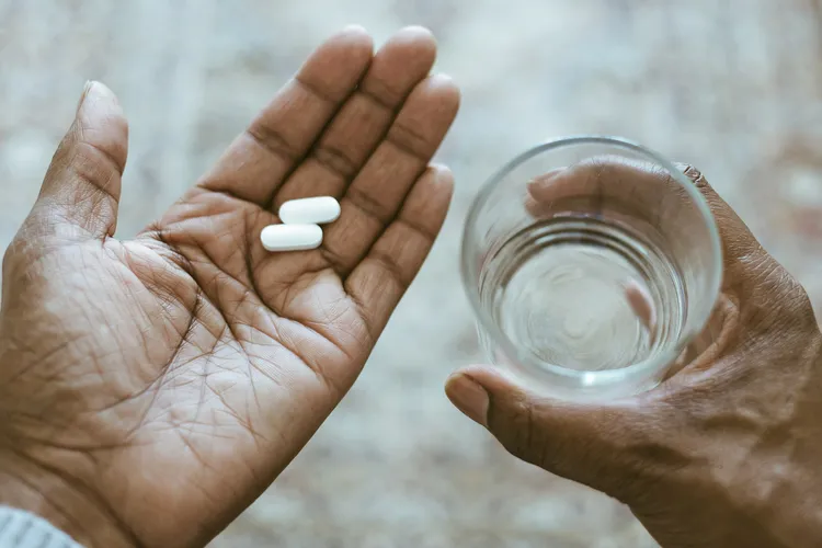 photo of Hands Holding Pills