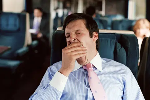 photo of man yawning on train