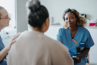 photo of care team talking to patient