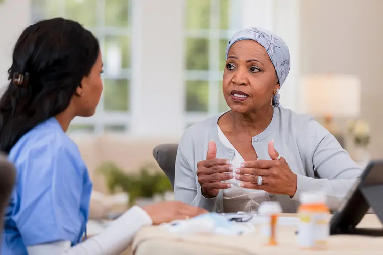 photo of chemo patient talking with nurse