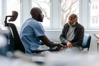 photo of doctor talking to senior patient