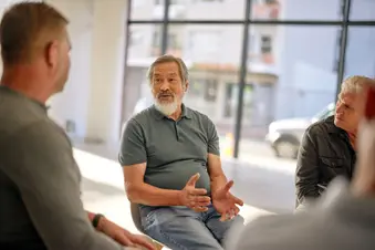 photo of senior man talking in support group
