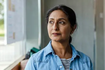 photo of mature woman gazing out window
