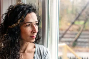 photo of woman looking out window