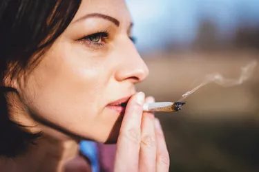 If you consume THCA, it can ease pain or nausea but won’t make you feel high. If you smoke or vaporize THCA, it changes into THC, which is what gives you a euphoric feeling. (Photo Credit: iStock/Getty Images)