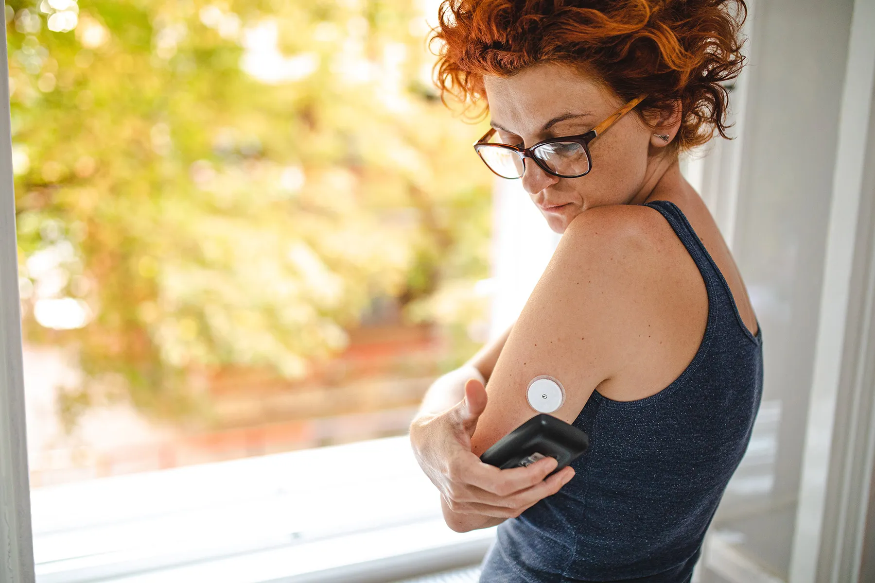 photo of checking blood sugar with device reader