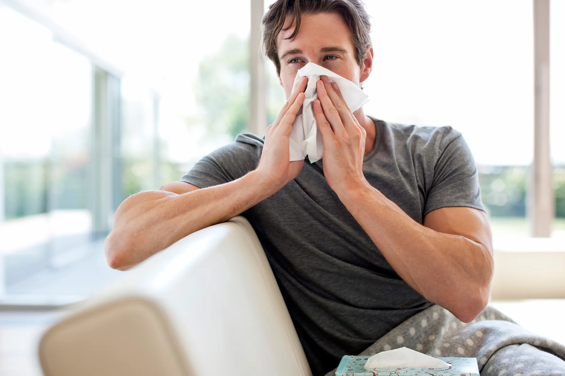 photo of man blowing his nose